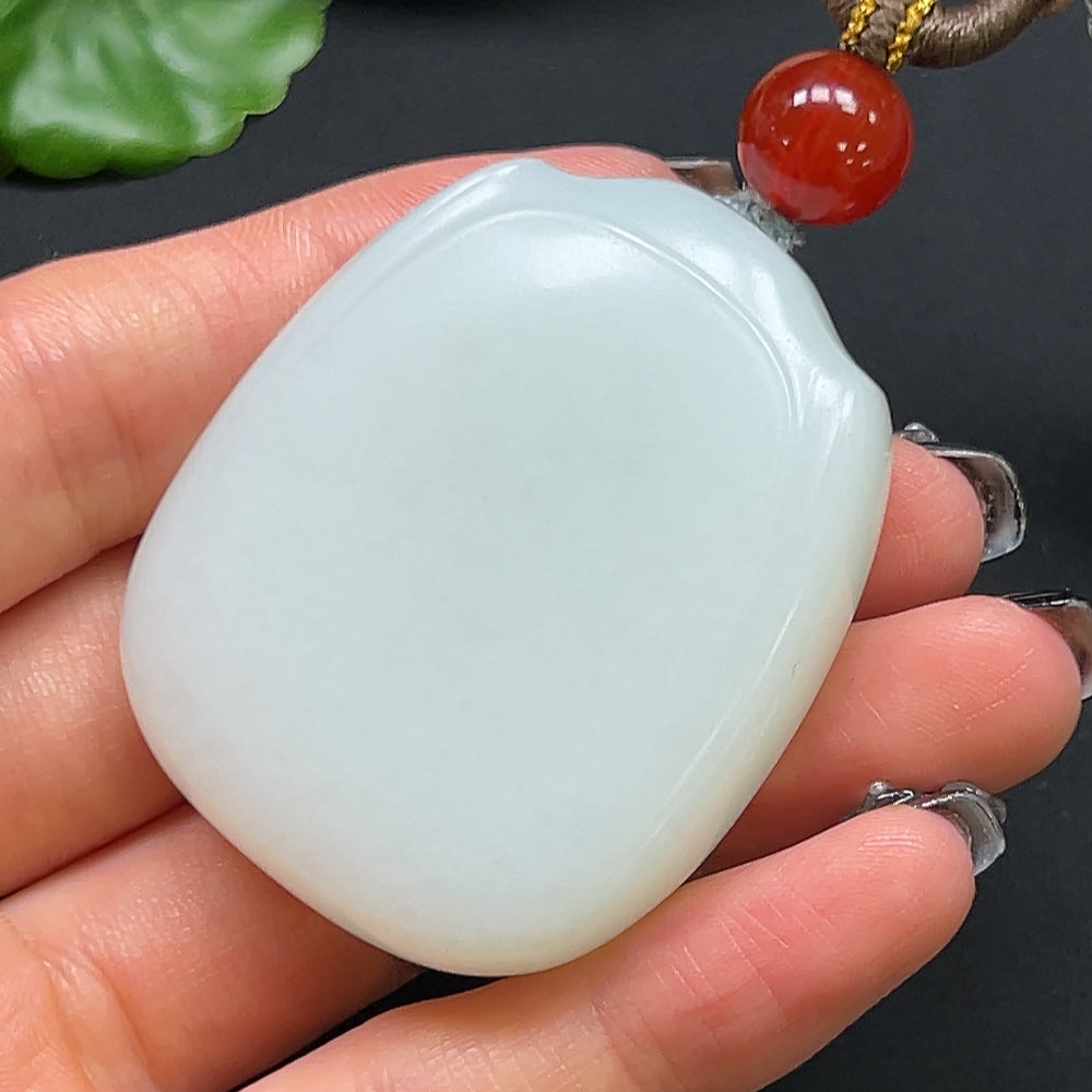 Hetian jade plain pendant with rope necklace, HKHQ brand, showcasing smooth jade surface and elegant design on a white background.