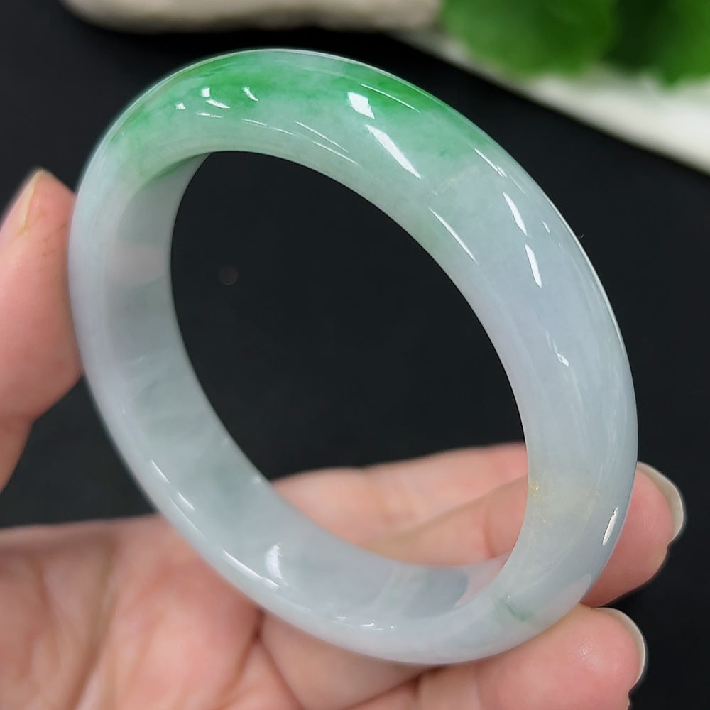 Jadeite round bracelet with size 53.8, approx. 54g weight, featuring smooth, polished jade stones on a jewelry display.