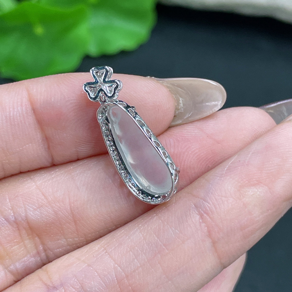 Jadeite pendant in bean shape with 18k gold inlay and diamond accents, weighing approximately 1.4g, by HKHQ.