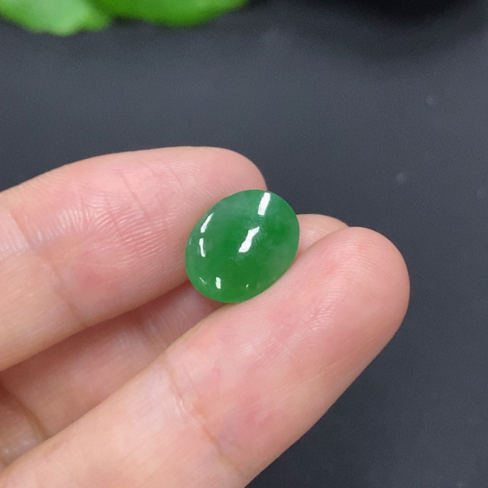 Smooth jadeite cabochon jewelry piece, approximately 1.1g, showcasing vibrant green color and polished surface.