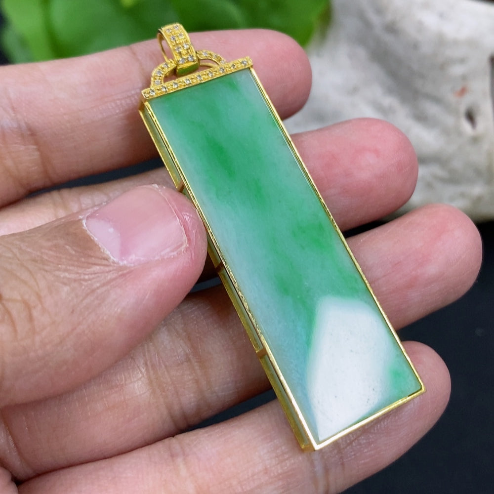 Jadeite pendant necklace with 18K gold setting and diamond accent, shown with a sleek jade pendant on a chain.