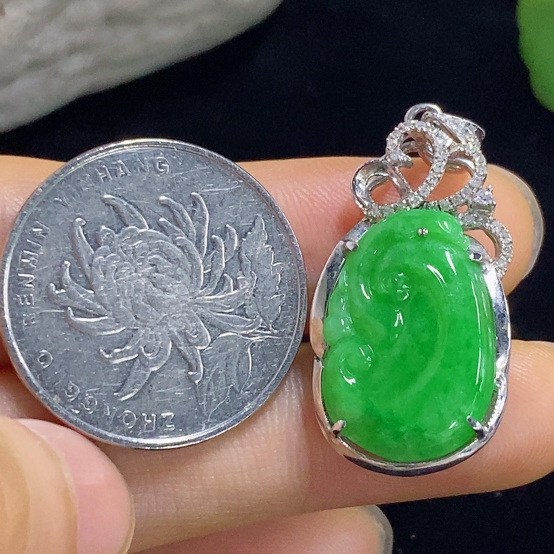 Jadeite Ruyi pendant with gold accents and diamond details, featuring inlaid design, 3.75g weight, on a necklace chain.