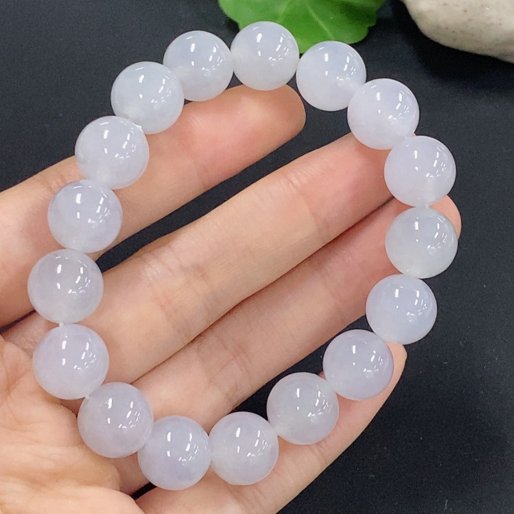 Jadeite bracelet with 11.5mm beads, approximately 43.88g, showcasing smooth, polished jade stones on a HKHQ branded bracelet.