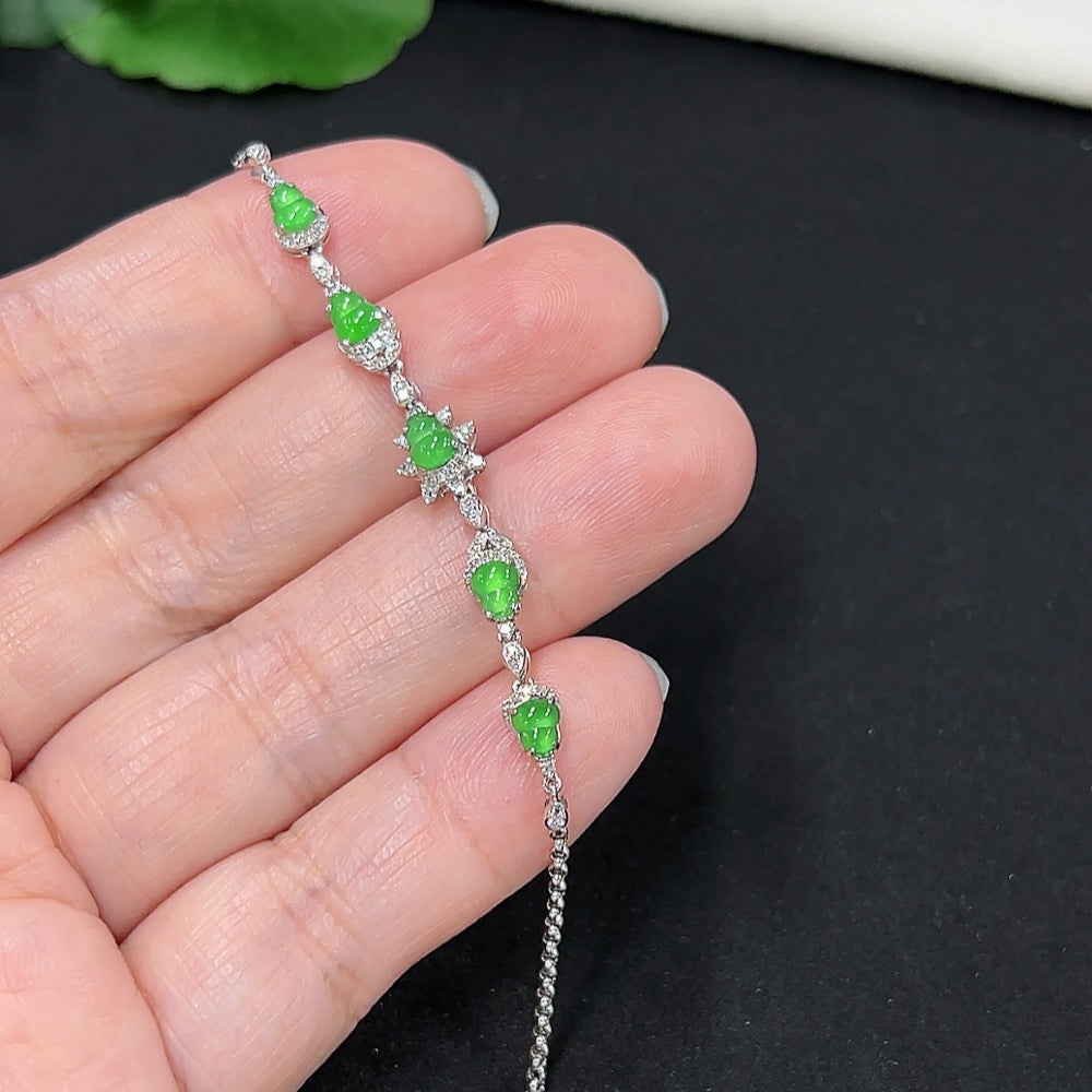Jadeite gourd inlaid bracelet by HKHQ with 18k gold and diamond accents, showcasing detailed craftsmanship and elegant design.