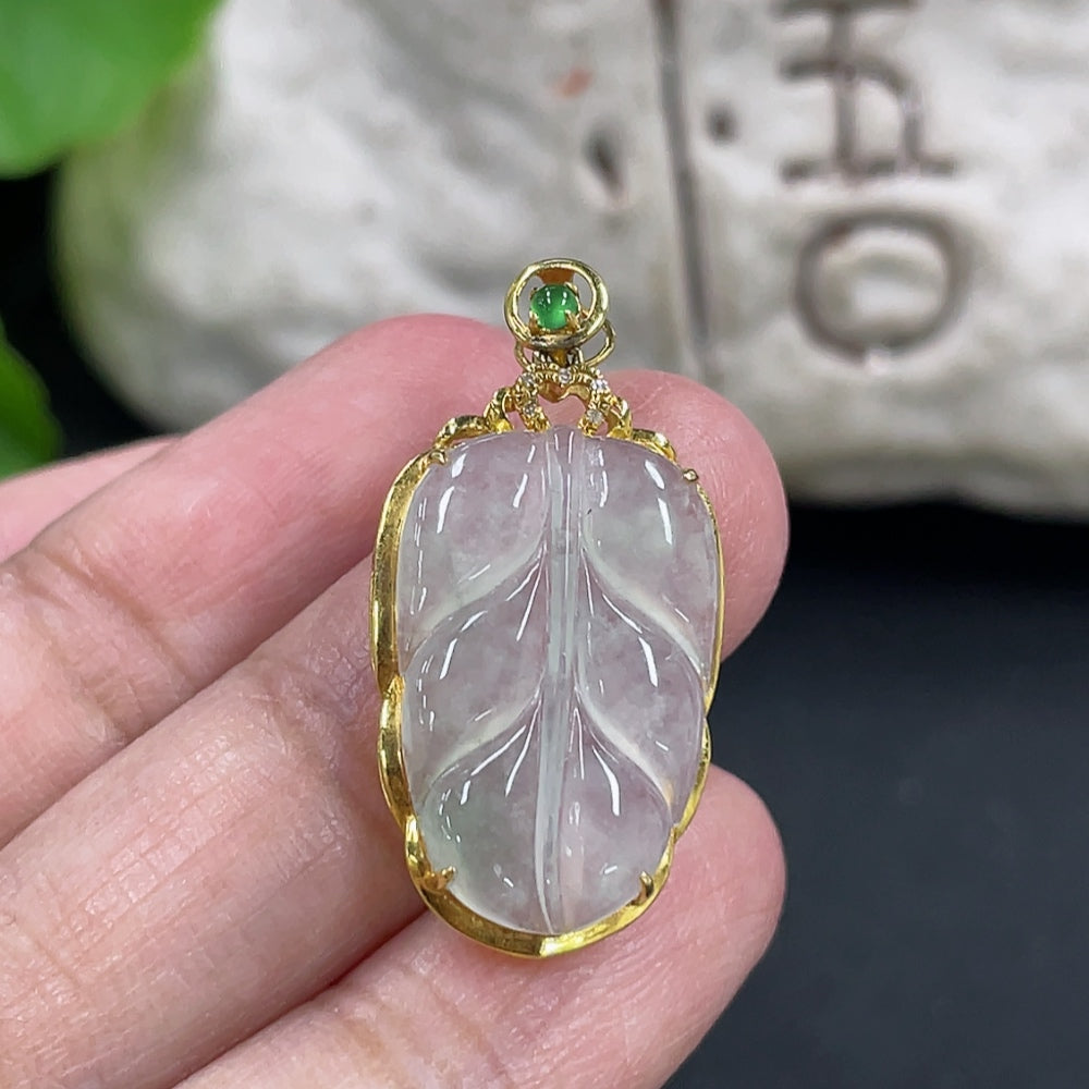 Jadeite leaf pendant with 18k gold inlay and diamond accents, weighing approximately 2.17g, from HKHQ.