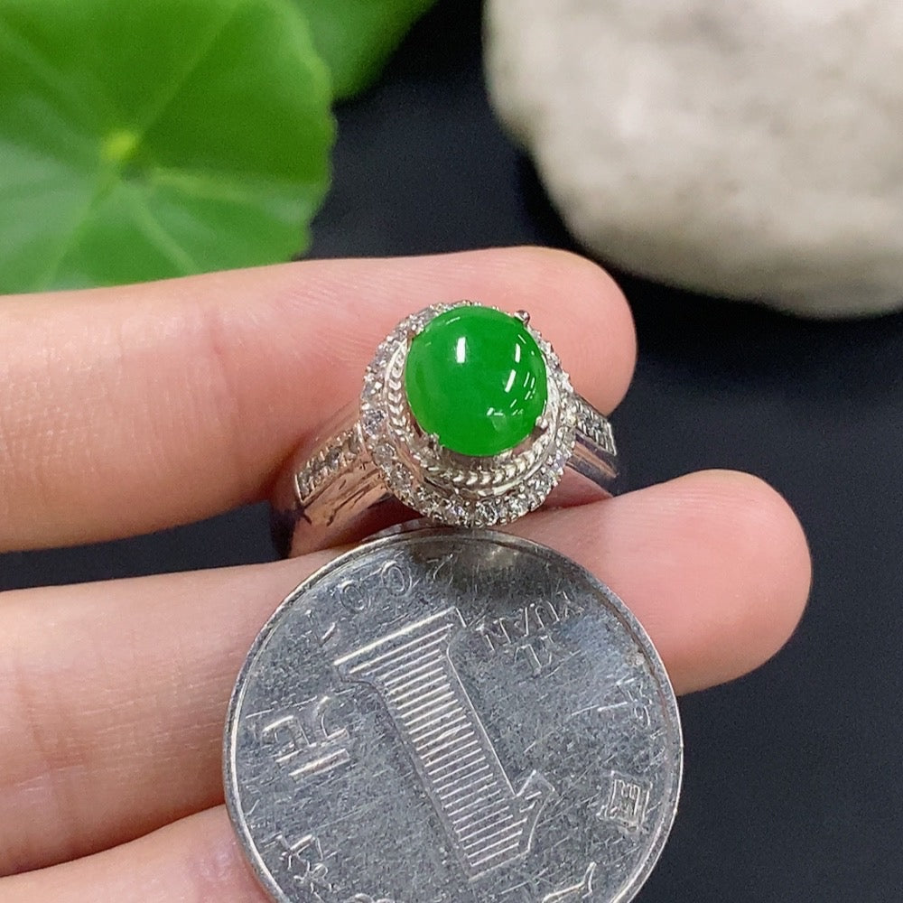 Jadeite cabochon jewelry set in a non-gold metal setting, featuring polished green gemstone with smooth rounded surface.