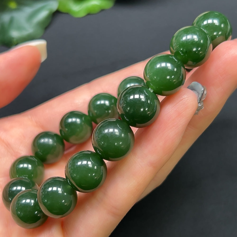 Hetian Jade bracelet with 12mm beads, weighing approximately 44.19 grams, featuring smooth green jade stones.