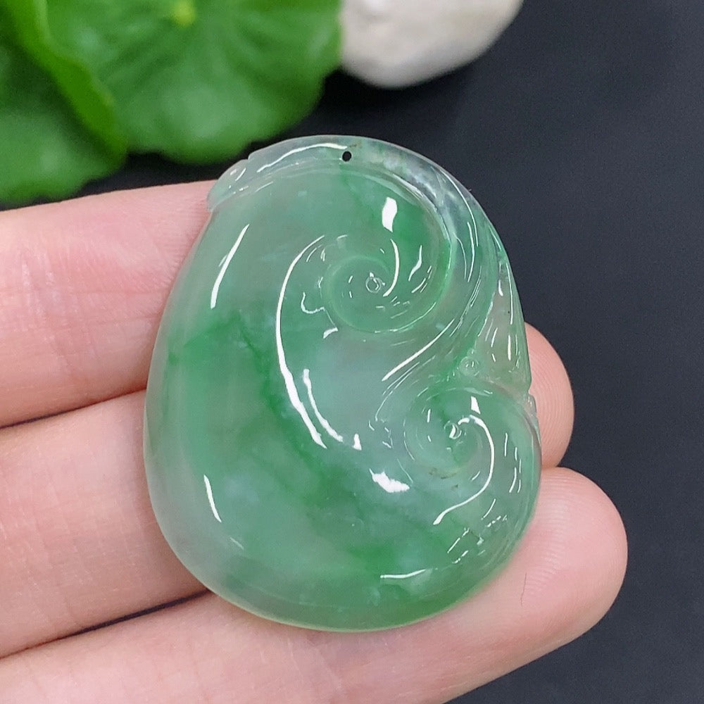 Jadeite Ruyi pendant with intricate carvings, weighing approximately 10.5g, crafted by HKHQ, showcasing smooth, polished jade surface.