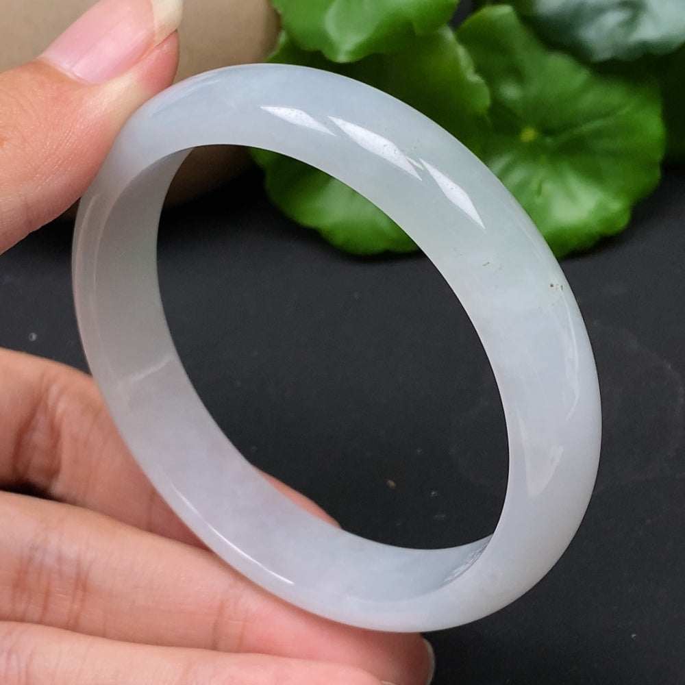 Jadeite round bangle in size 56.5, weighing approx. 43.17g, featuring smooth, polished green jade from HKHQ.