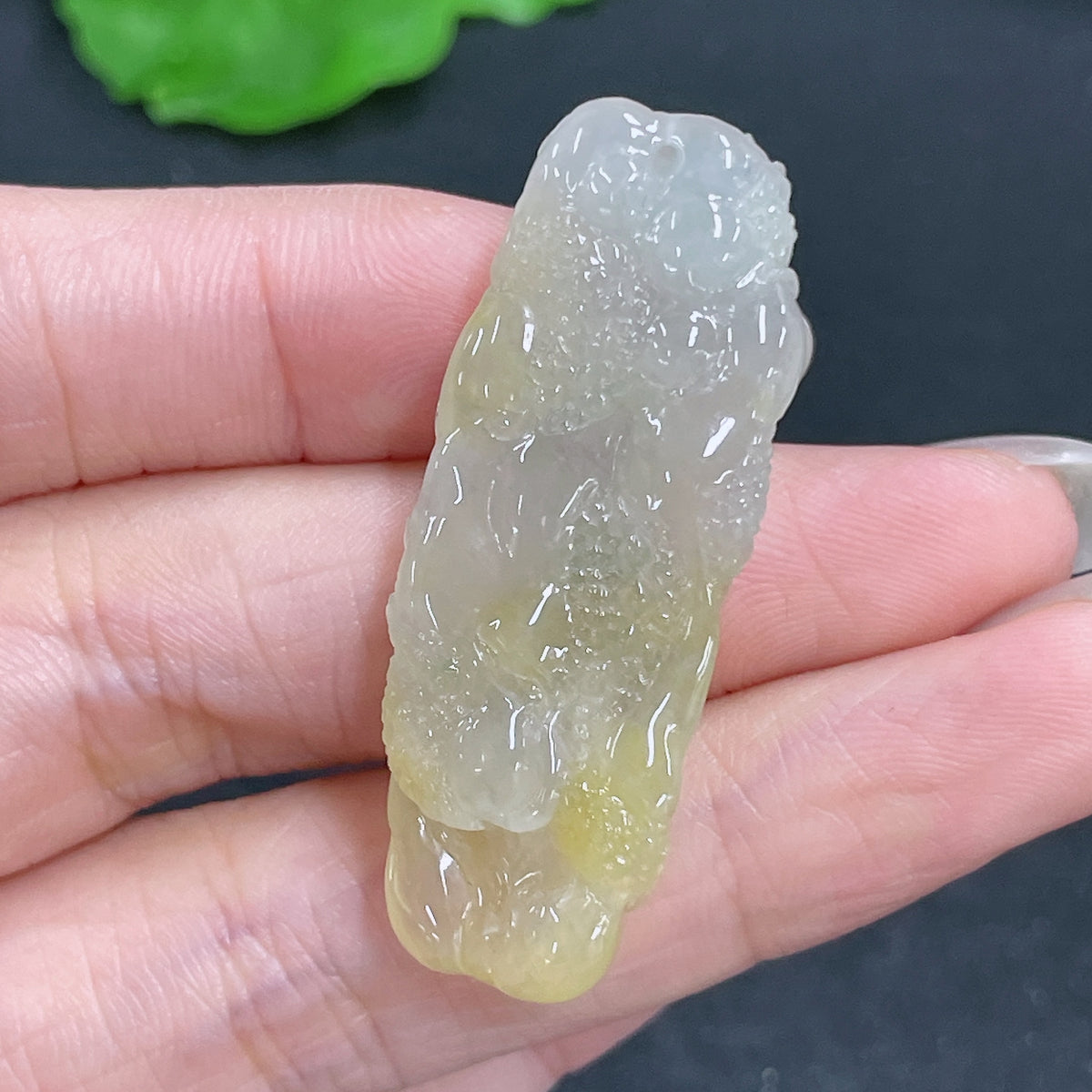 Jadeite pendant featuring a carved dragon plaque, weighing approximately 10g, showcasing intricate jade craftsmanship.