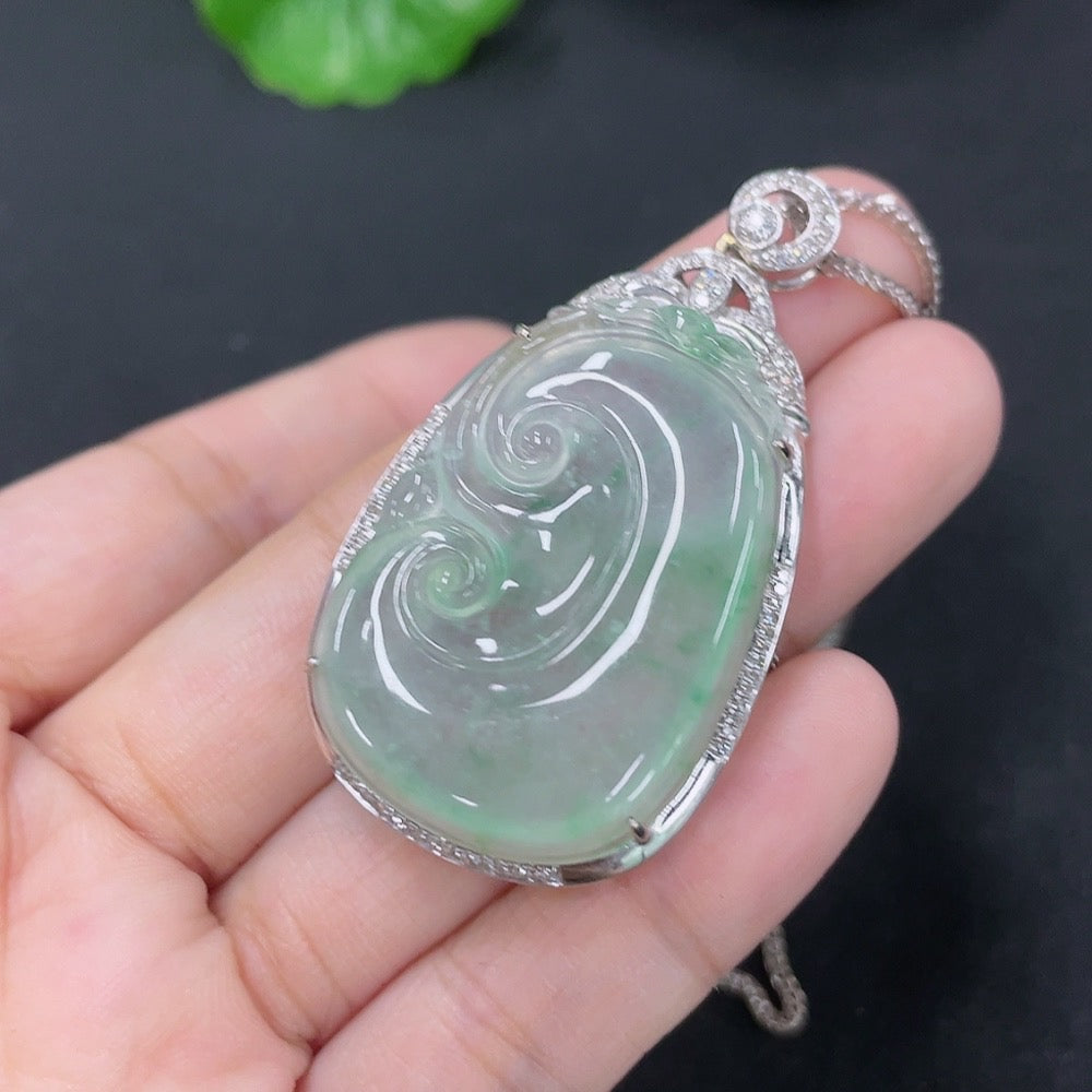 Jadeite Ruyi pendant with 18K gold accents and diamond details, showcasing intricate inlay work and elegant design.