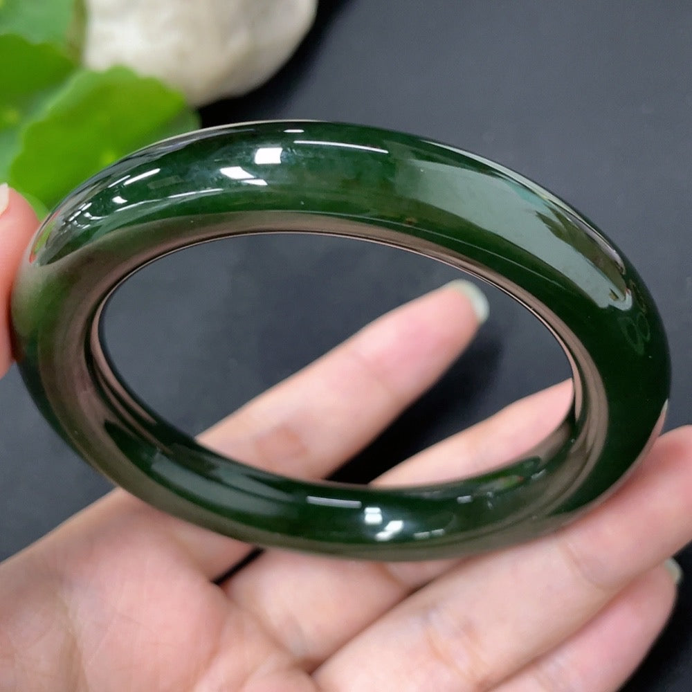 Green Hetian Jade round bangle by HKHQ, 56.7mm size, weighing approximately 58.8g, showcasing smooth, polished jade surface.