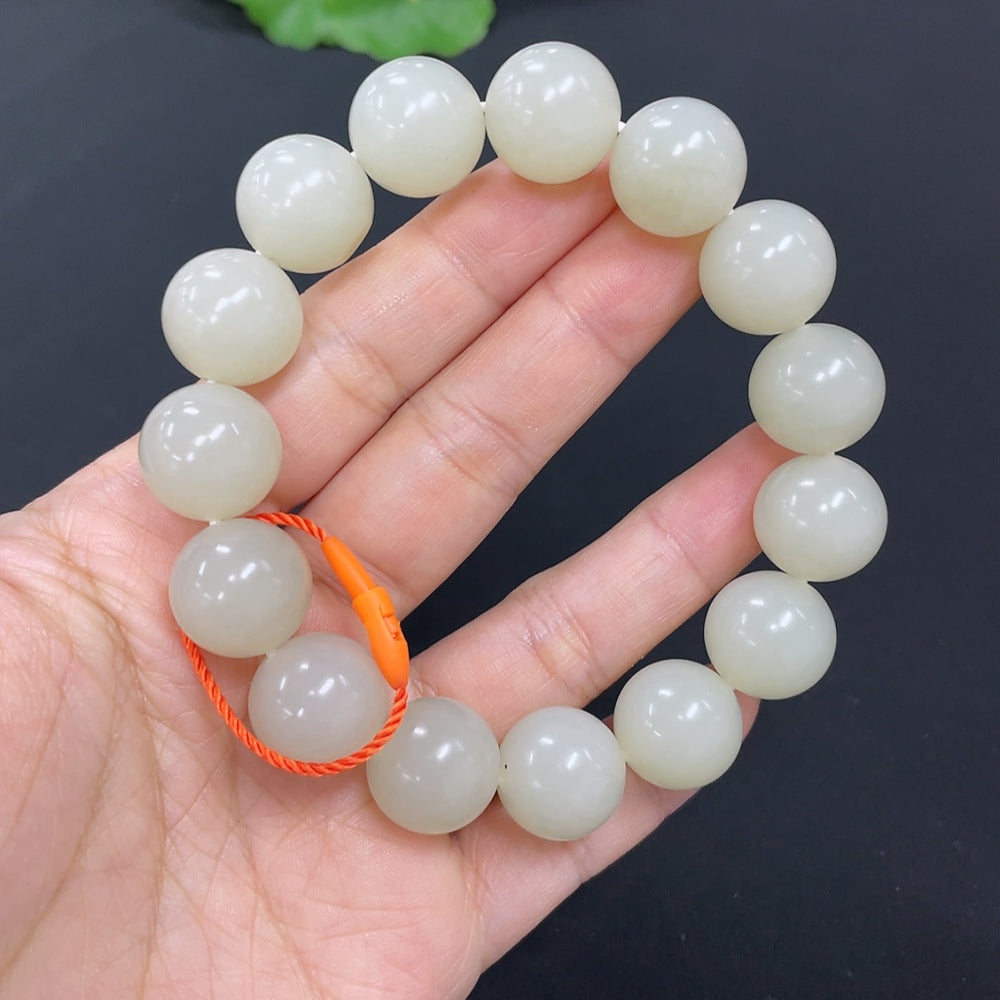 HKHQ Hetian jade bracelet with 13.9mm beads and 64.2g weight, featuring smooth, polished jade stones on a natural skin color background.