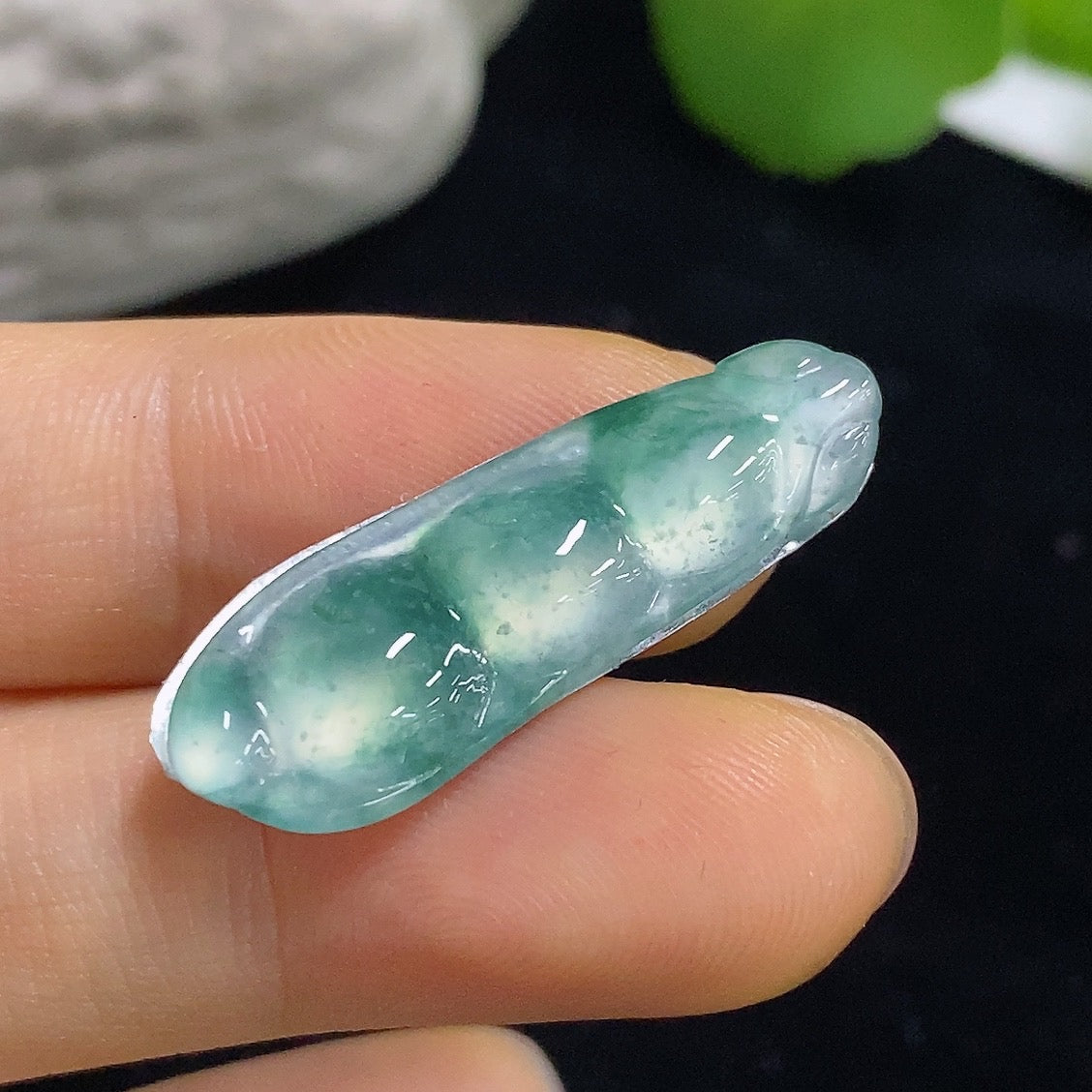 Jewelry piece featuring a jadeite lucky bean inlay, weighing approximately 1.82g, from HKHQ.