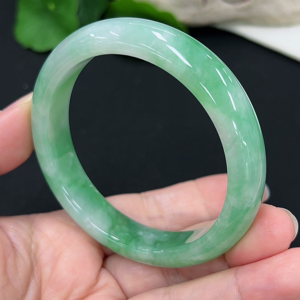 Round jadeite bangle with a smooth finish, size 55.1, weighing approximately 50.4g, displayed on a neutral background.