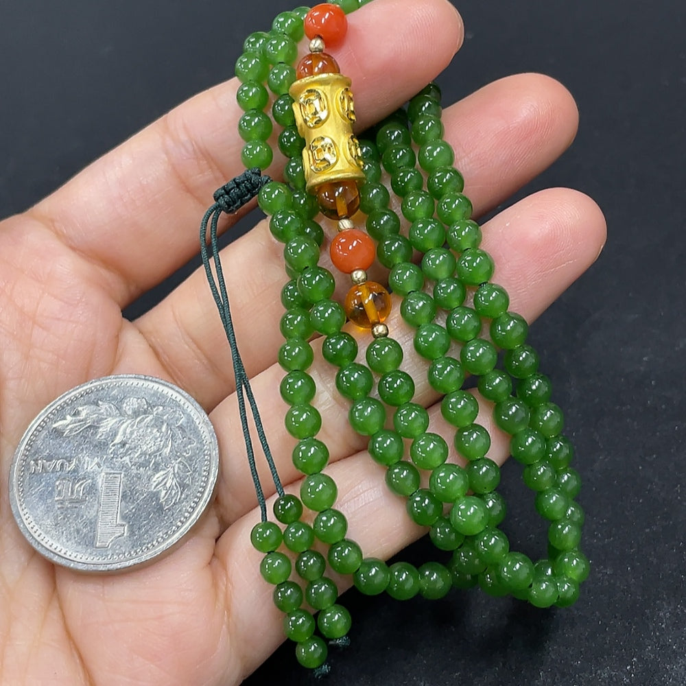 HKHQ Hetian Jade beaded necklace featuring smooth, polished jade beads strung together in a elegant design.