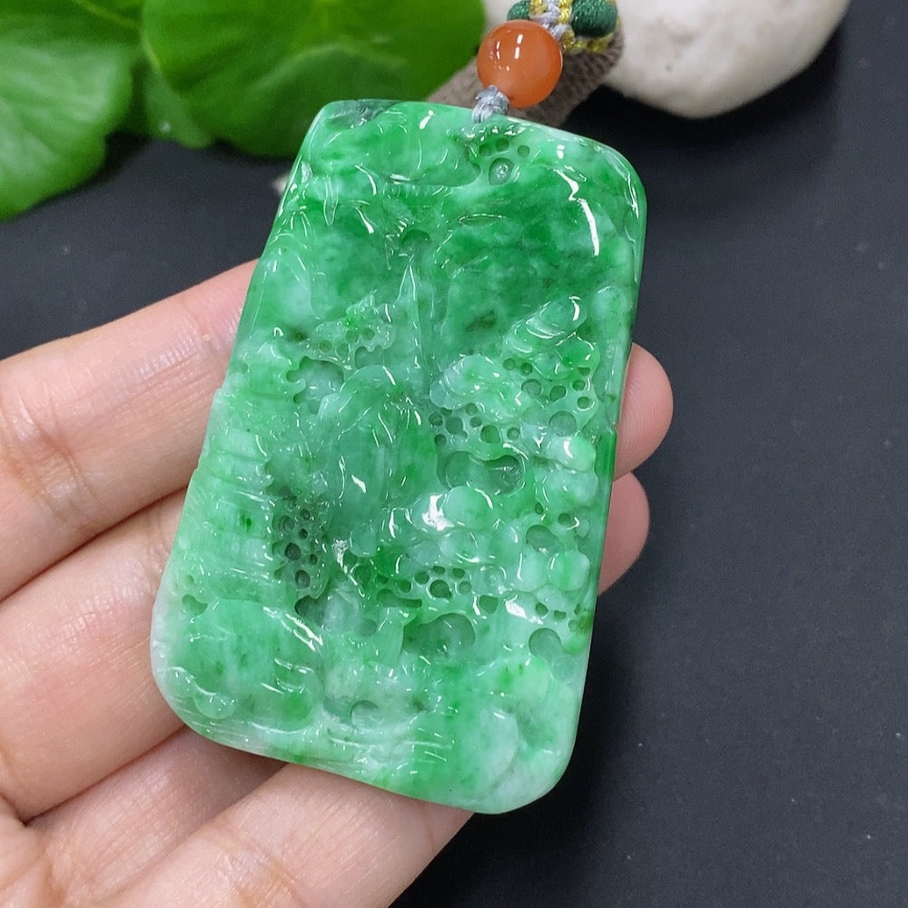 Jadeite landscape pendant with rope, showcasing detailed green jade carving, from HKHQ, weighs approximately 32.6g including the rope.