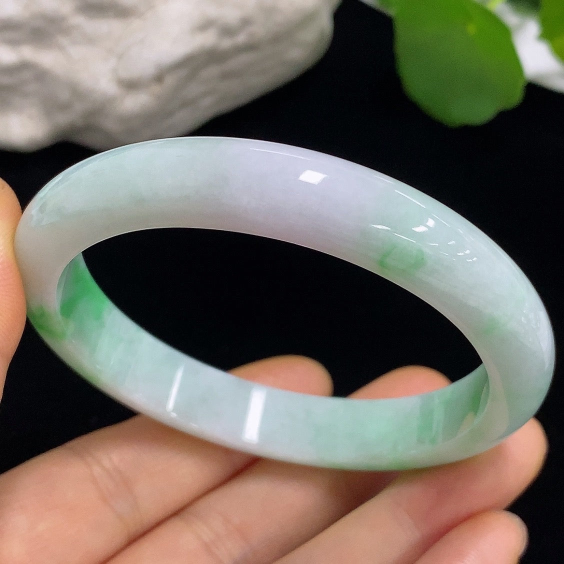 Jadeite round bangle with size 57.3 and weight 43.82g, showcasing smooth, polished jade surface with a rich green hue.