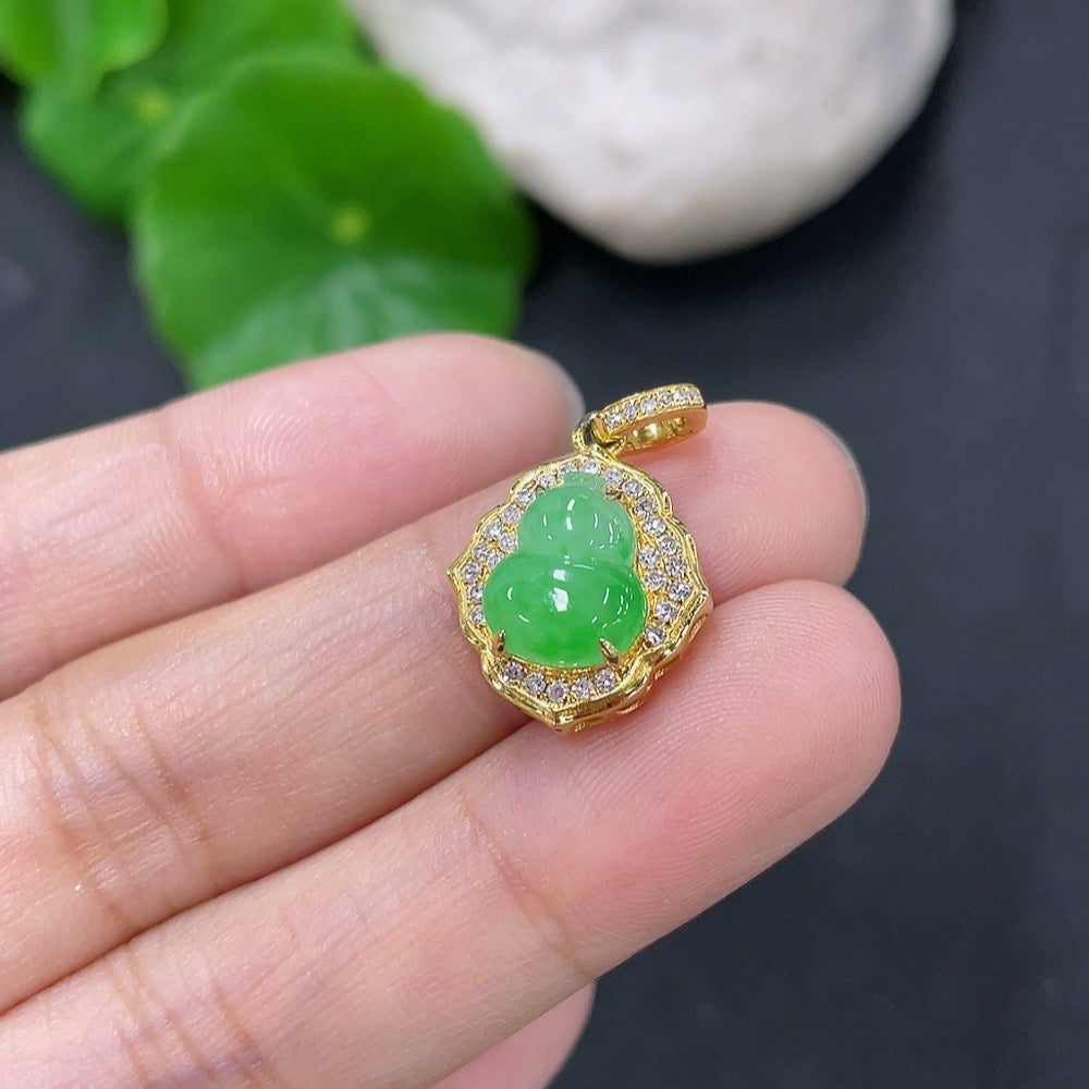 Jadeite inlaid gourd pendant by HKHQ featuring 18k gold and diamond accents, weighing approximately 1.74 grams.
