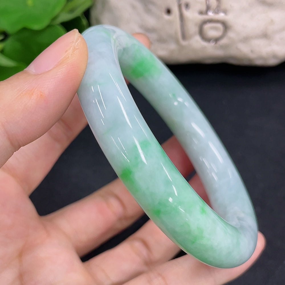 HKHQ jadeite round bangle weighing 80.5g and size 56.2, showcasing smooth, polished green jade jewelry on a clean background.