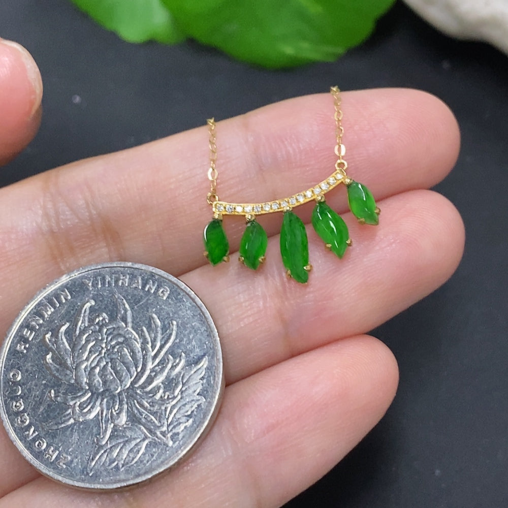 Jadeite inlaid pendant with 18K gold and diamond accents, featuring a delicate jade stone design and intricate craftsmanship.