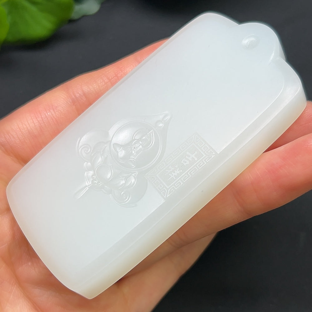 Hetian Jade Guanyin pendant necklace from HKHQ featuring a detailed carved jade figure on a string.