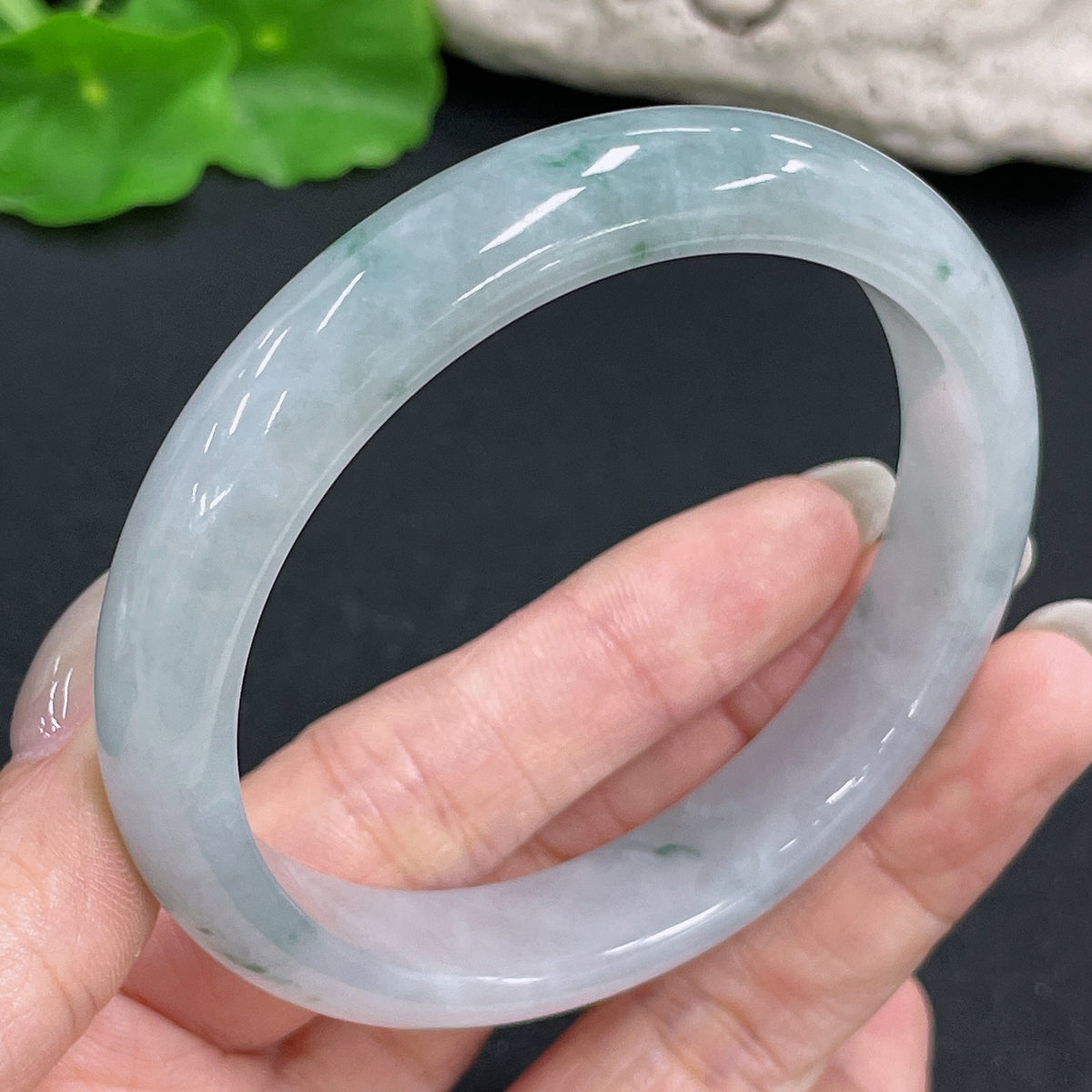 Jadeite round bangle in size 59.3, weighing approximately 51.46g, showcasing smooth, polished green jade from HKHQ.