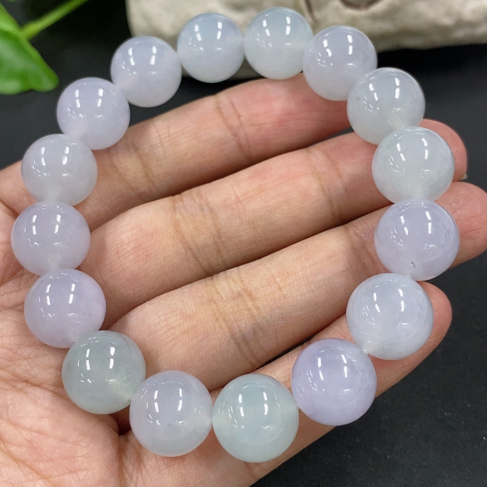 HKHQ jadeite bracelet with 12mm beads, weighing approximately 49.7g, showcasing smooth, polished jadeite stones.