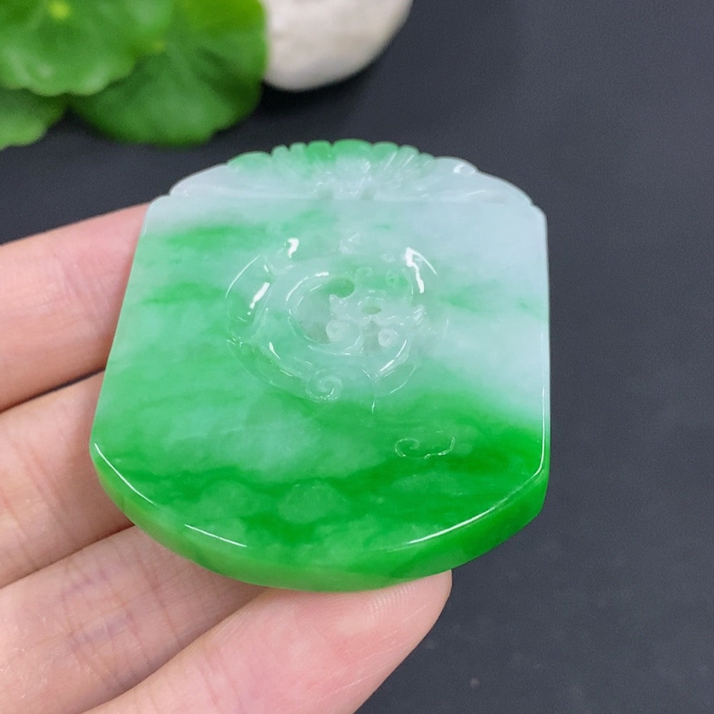 Antique jadeite pendant from HKHQ, weighing approximately 35.1g, showcasing smooth green jade with intricate carvings.
