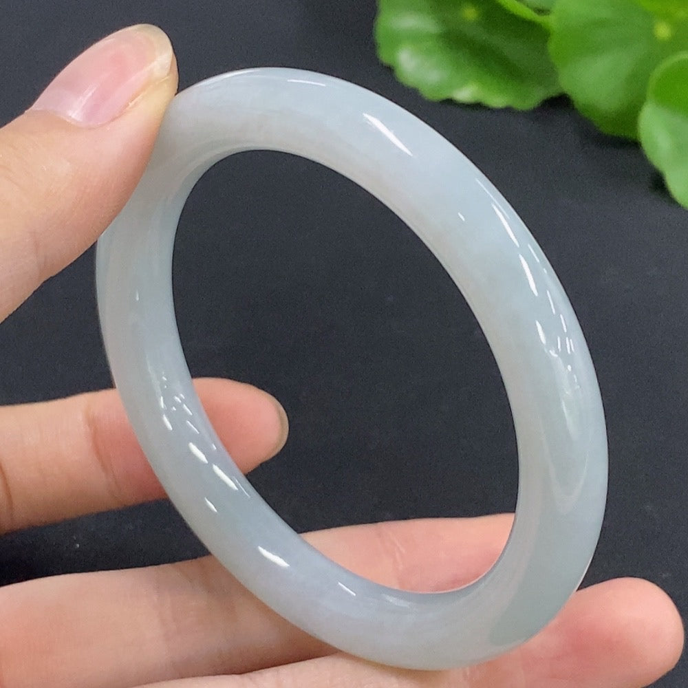 Jadeite round bangle in size 52, weighing approximately 35.12g, showcasing smooth, polished green jade from HKHQ.