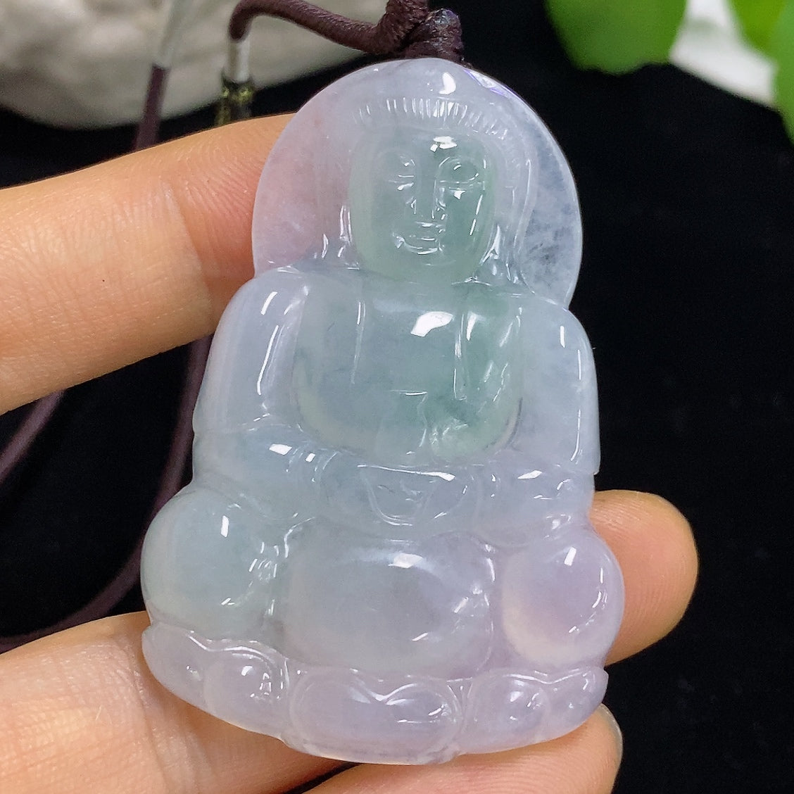 Jadeite Guanyin pendant with intricate carving, hanging from a rope, weighing approximately 21.6g, crafted by HKHQ.