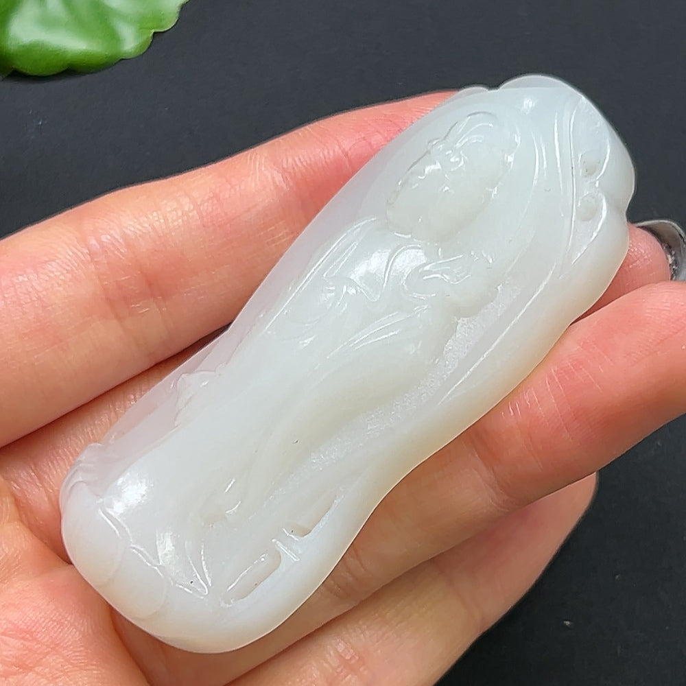 Hetian Jade Guanyin pendant necklace featuring a detailed carved figure, crafted by HKHQ.