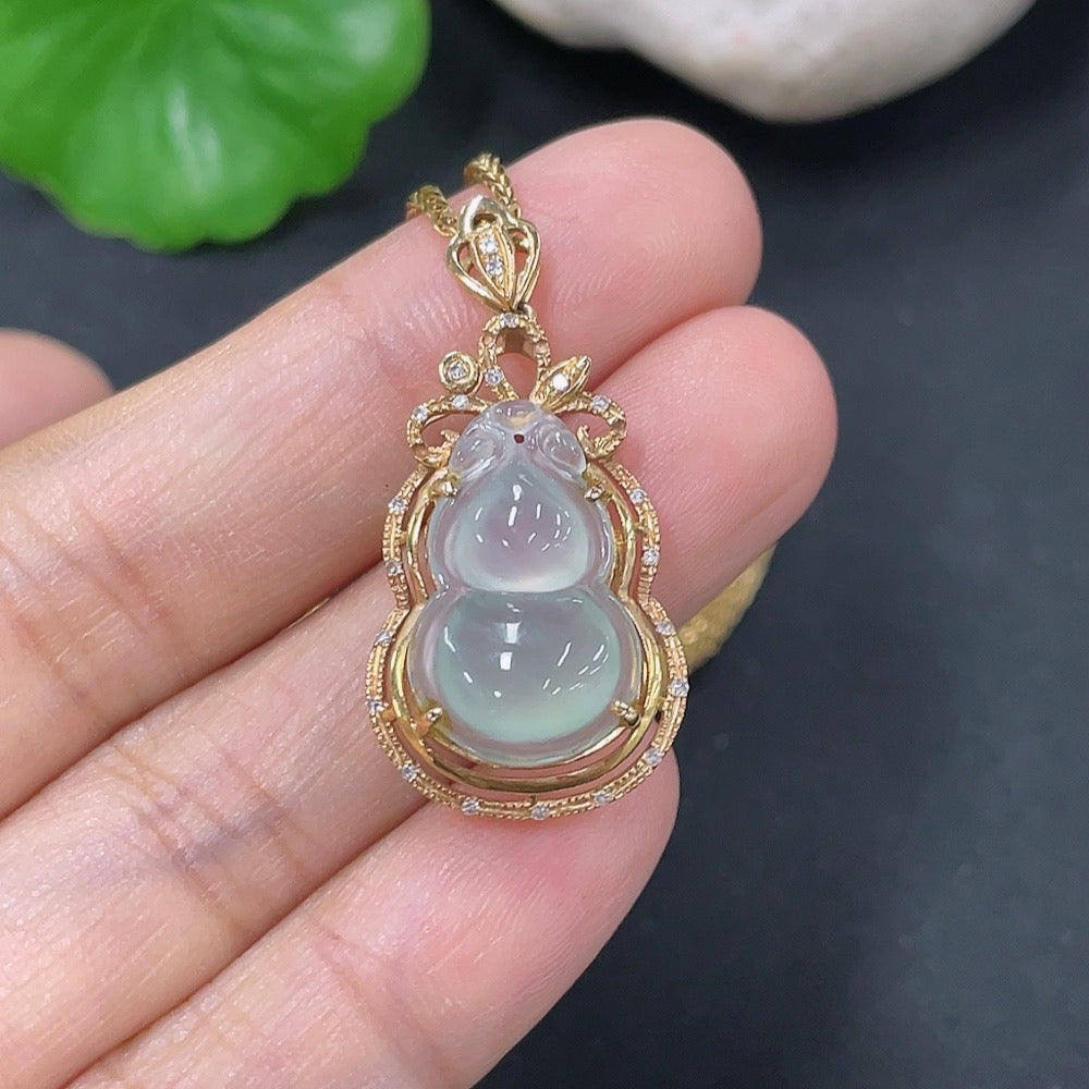 Jadeite gourd pendant set in 18K gold with diamond accents, showcasing a polished jade pendant and matching jewelry.