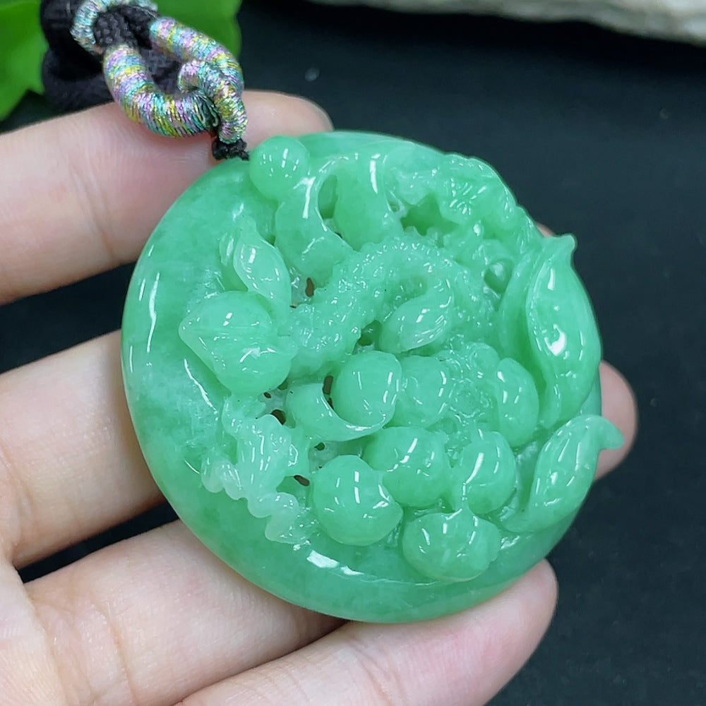 Jadeite lotus pendant necklace by HKHQ featuring a detailed carved lotus design and a rope chain, weighing approximately 48.61g.