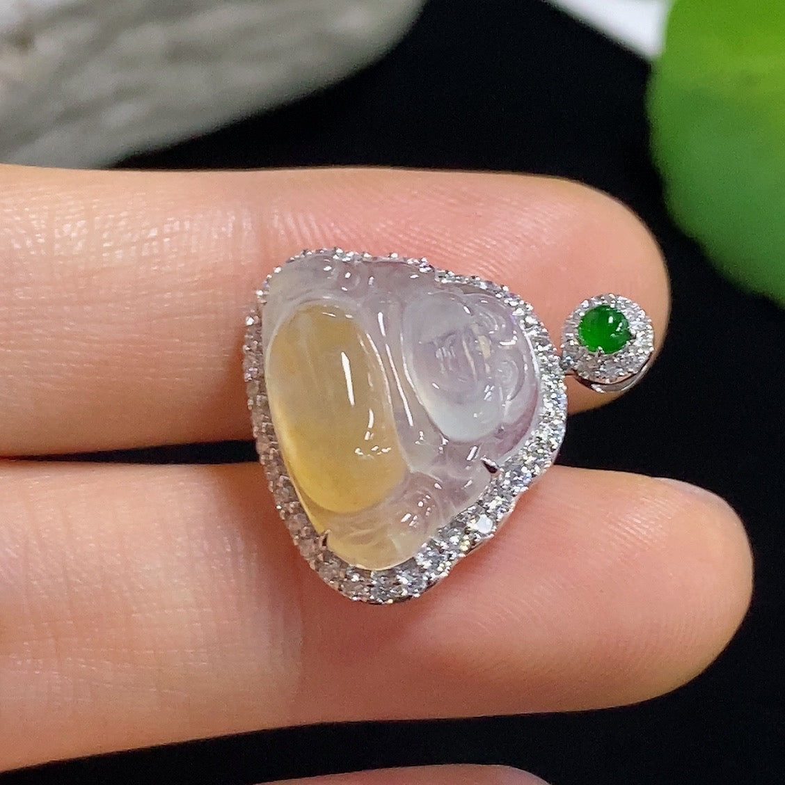 Jadeite Buddha pendant necklace with 18K gold and diamond accents, showcasing detailed craftsmanship and elegant design.