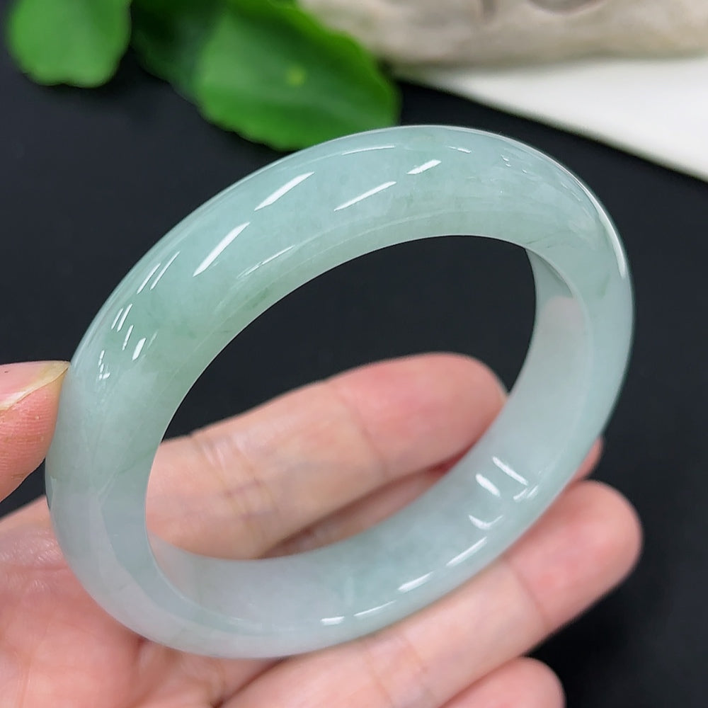 Jadeite round bangle in size 53.7 with a total weight of 56.5g, showcasing smooth, polished jadeite from HKHQ.