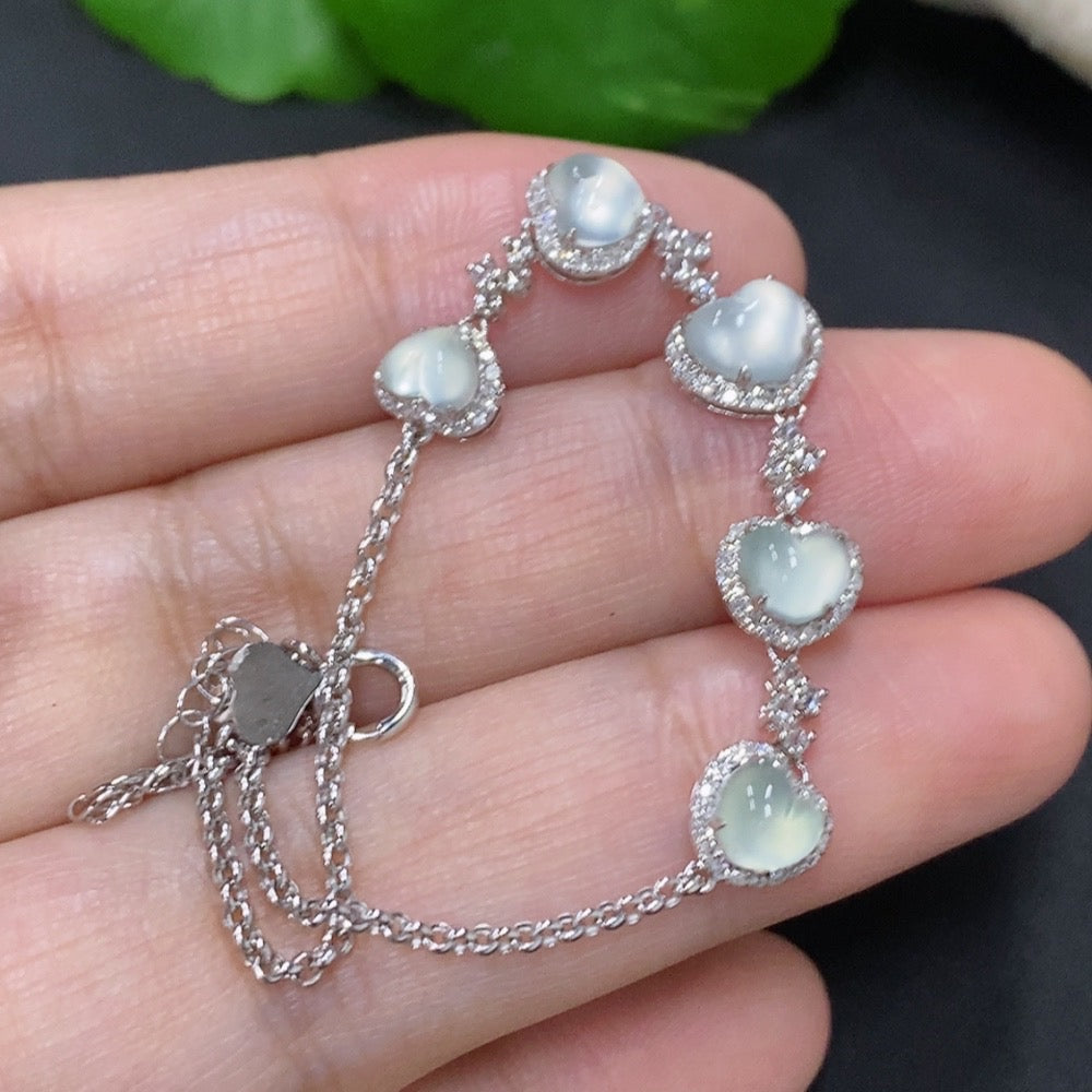 Jadeite inlaid bracelet with 18k gold and diamond accents, featuring intricate design and polished finish.