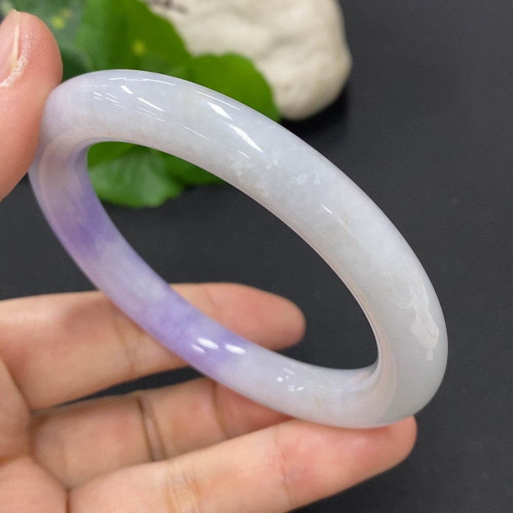 Jadeite round bangle with mineral inclusions, size 55.8mm, weighing approx. 49.81g, from HKHQ featuring smooth, polished surface.