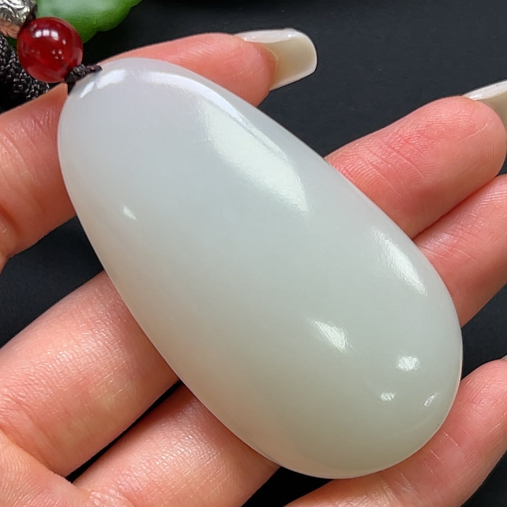 HKHQ Hetian Jade plain pendant on rope necklace, showcasing smooth, creamy jade with a polished finish.