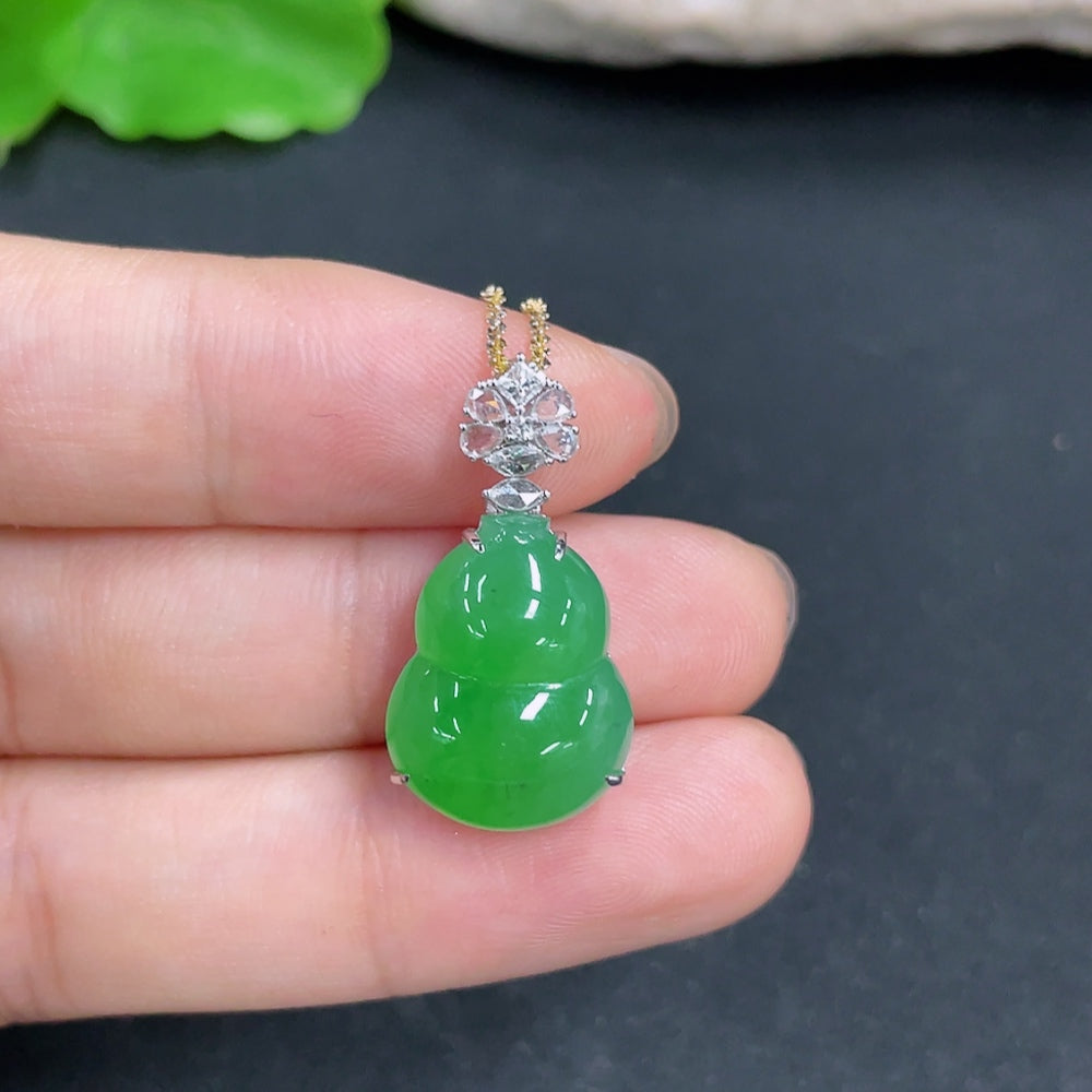 Jadeite gourd pendant with 18k gold and diamond inlay, showing the detailed jade surface and gold accents.