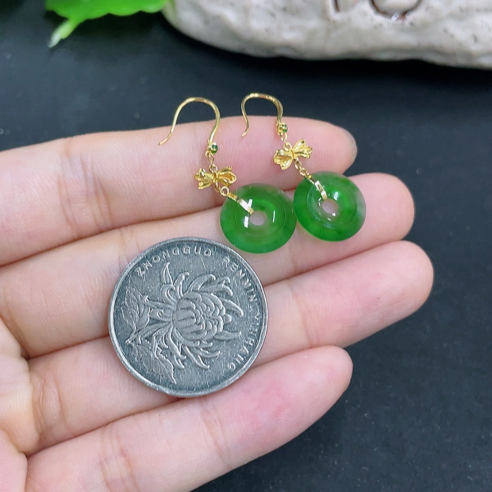 Pair of elegant jadeite earrings with 18k gold settings, showcasing smooth, polished jade stones and delicate craftsmanship.