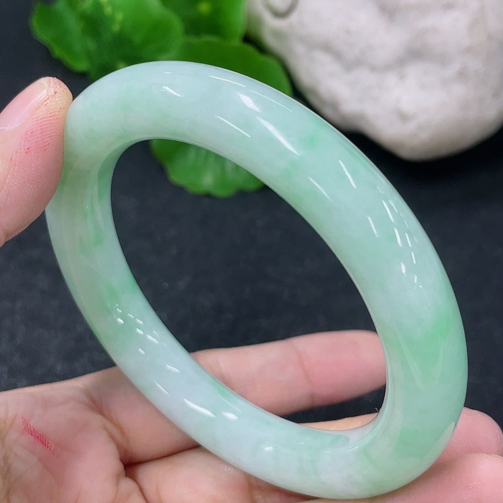 HKHQ Jadeite round bangle, 53.5mm, weighing approx. 55.86g, showcasing smooth, polished green jadeite bracelet on a neutral background.