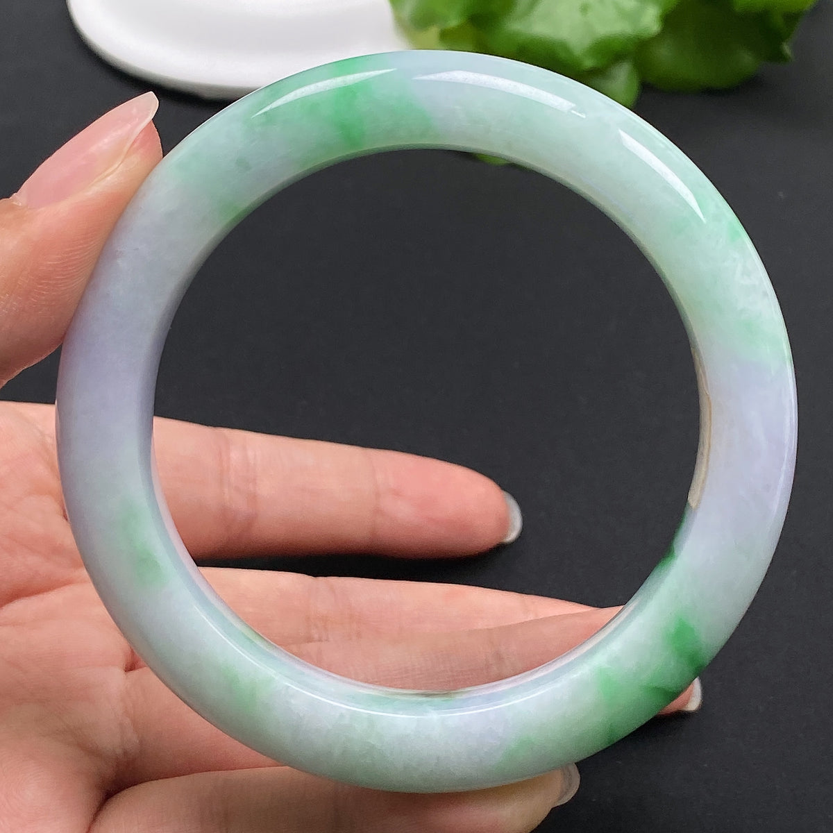 Jadeite round bracelet with size 57.9 and 69.23g weight, featuring smooth, polished green jade beads.