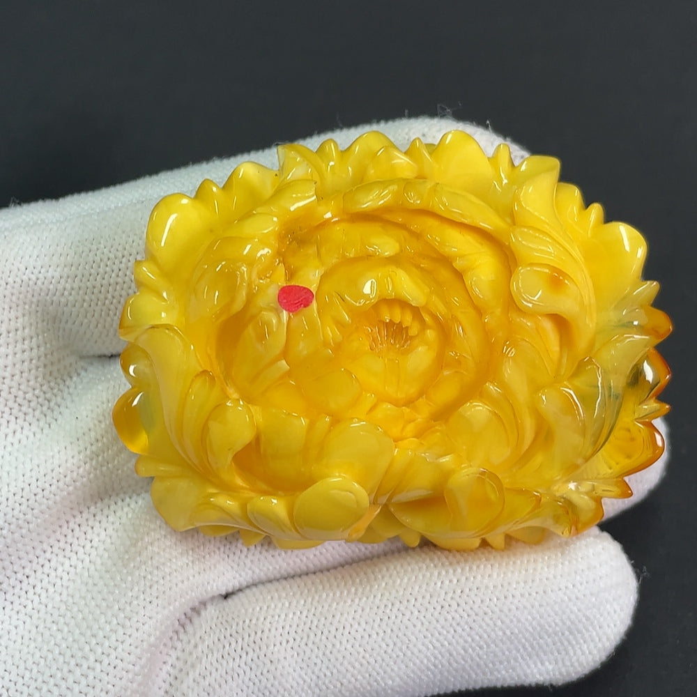 Amber beeswax pendant with partial visible repairs, weighing approximately 36.25g, from HKHQ, shown in close-up detail.