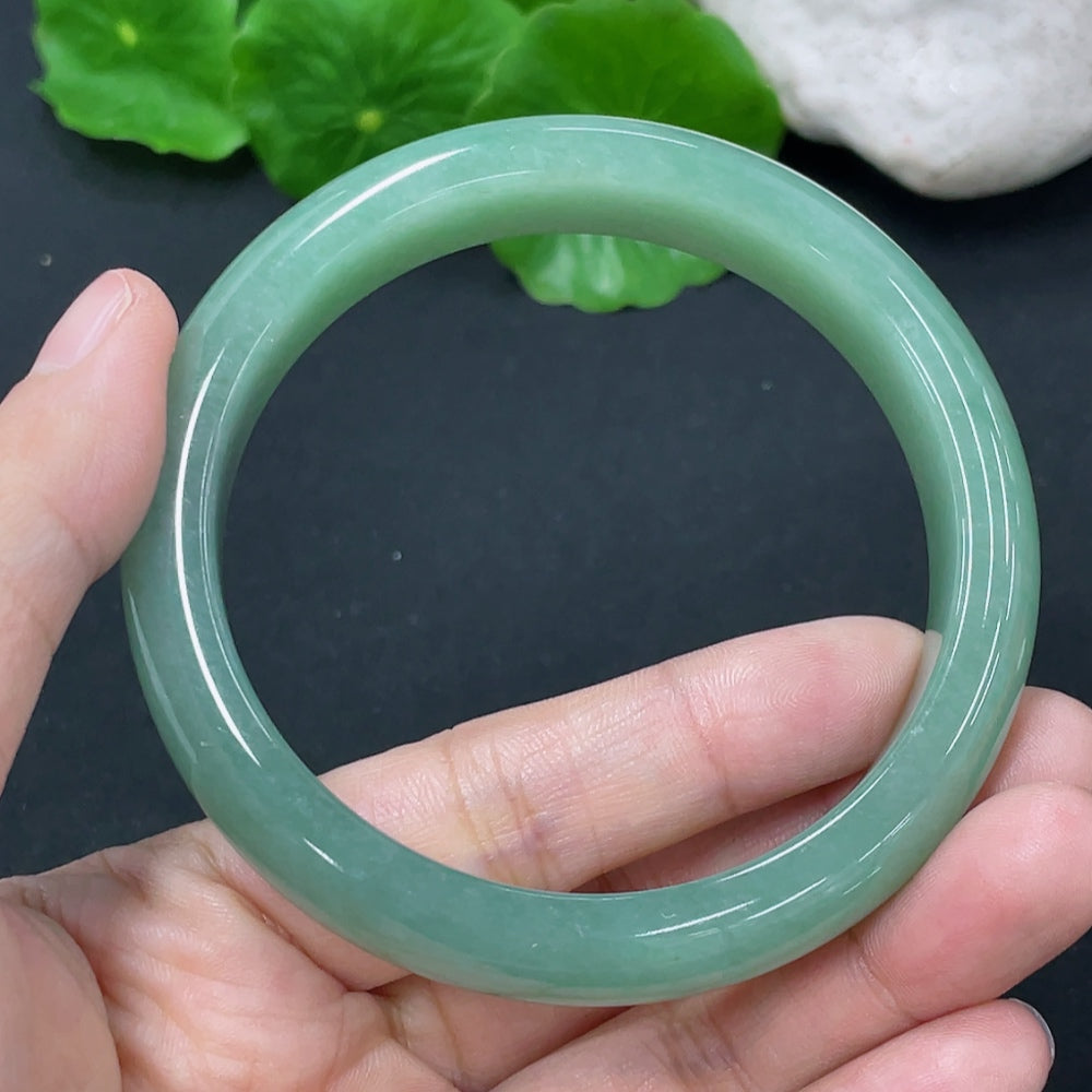 HKHQ jadeite round bangle weighing 54.38g, size 56.9, showcasing smooth, polished green jade with a glossy finish.
