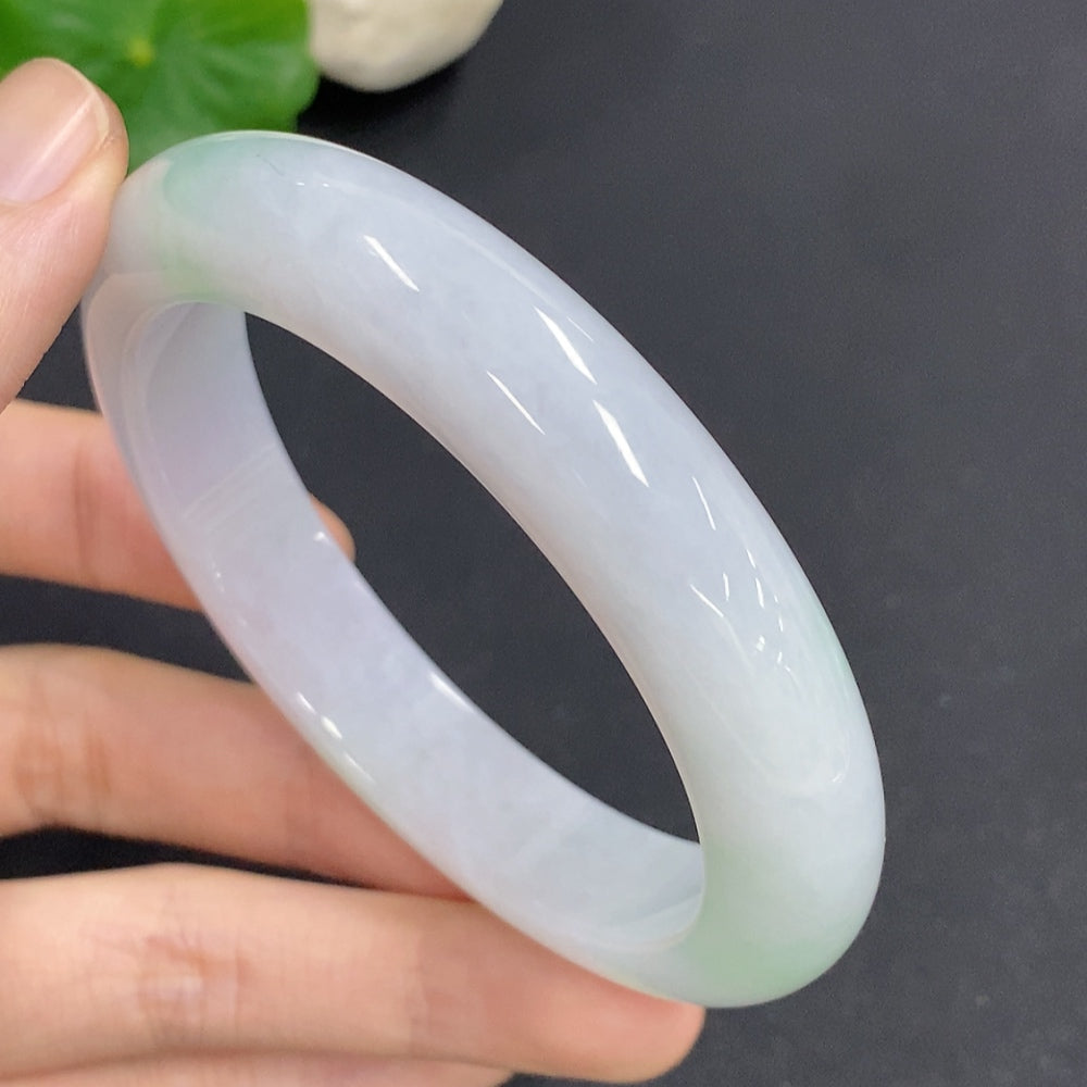Jadeite round bangle in size 58.7 with a total weight of 68.3g, showcasing smooth, polished jade surface and rich green color.