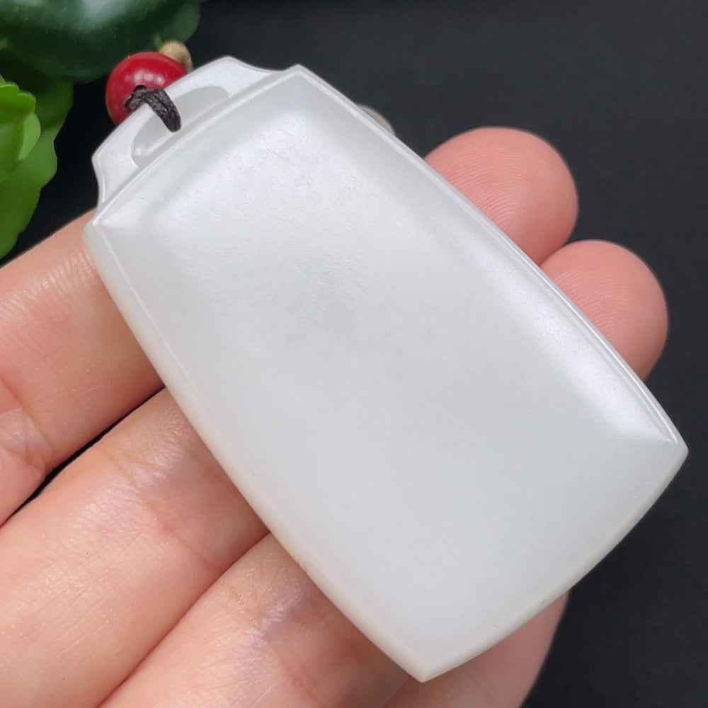 Hetian Jade plain pendant on rope necklace by HKHQ, showcasing smooth, polished jade with a natural green hue.