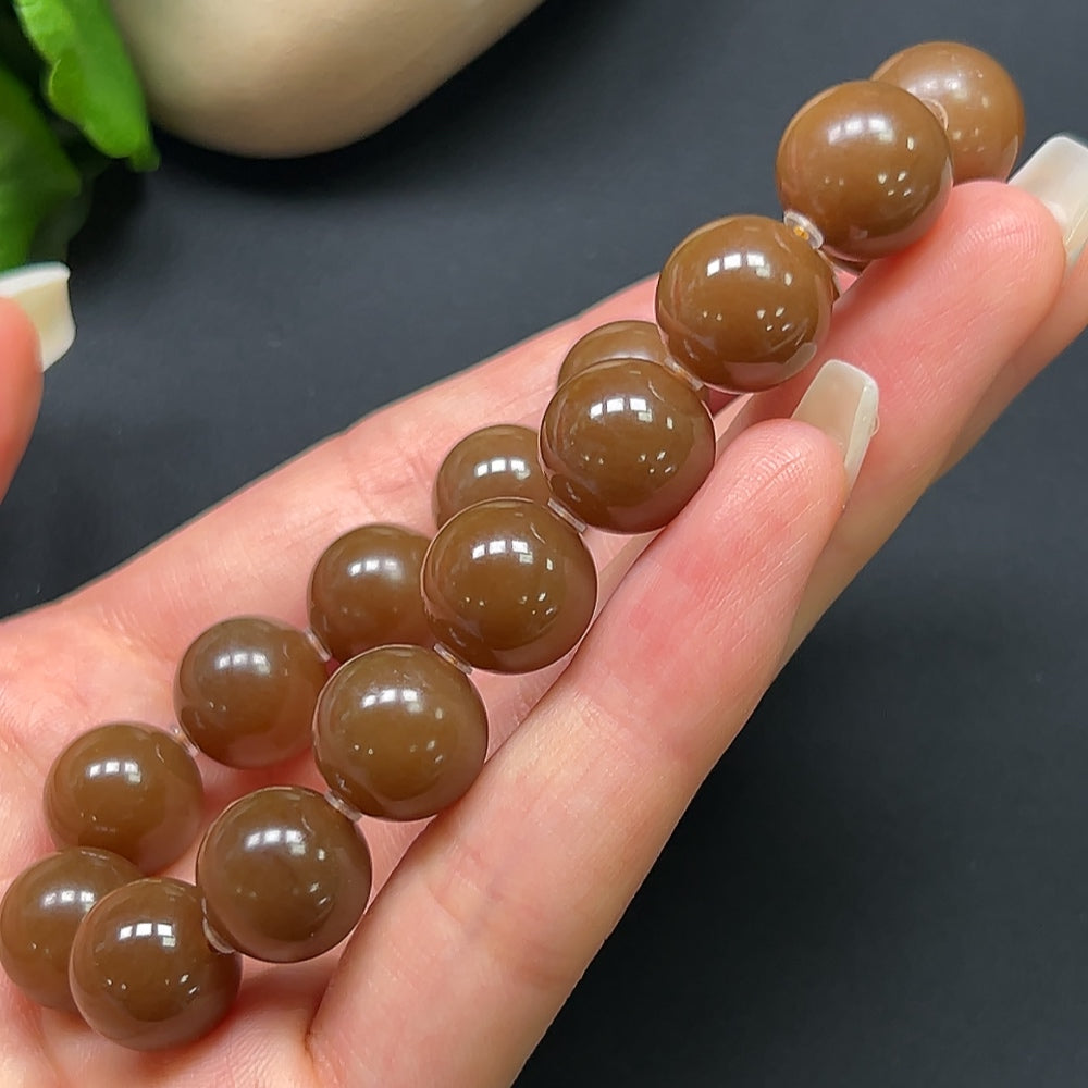 Hetian jade bracelet with 12.1mm beads, weighing approximately 43.69g, featuring smooth, polished green jade stones.