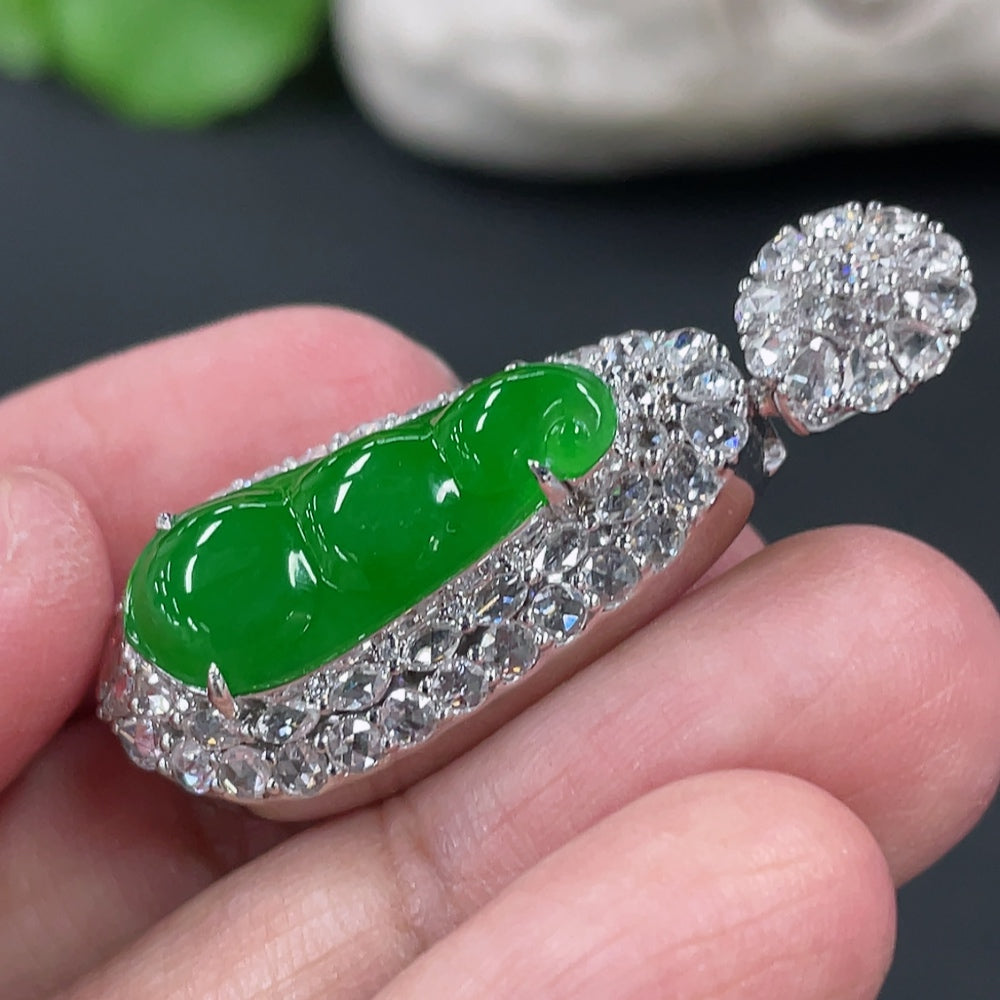 Jadeite blessed bean pendant with 18K gold setting and diamond accents, crafted by HKHQ, weighing approximately 8.17 grams.