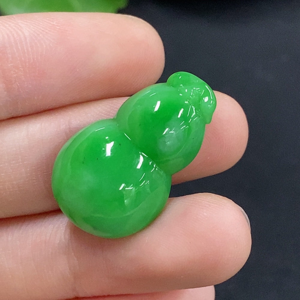 Jadeite gourd inlay piece with intricate design, weighing approximately 4.48g, crafted by HKHQ, showcasing smooth green jade texture.